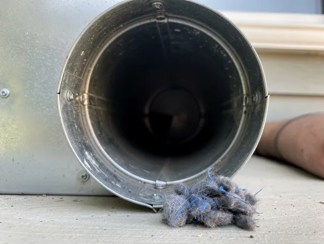 North Royalton Dryer Vent Cleaning technician using specialized equipment to clear severe dryer vent blockage in North Royalton